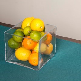 Glass vase with oranges, limes and lemons