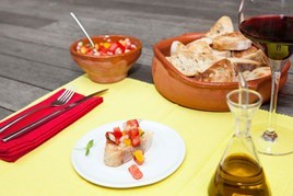 Spanish themed place setting with bread and salsa